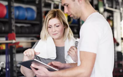 Woman talking to a fitness coach