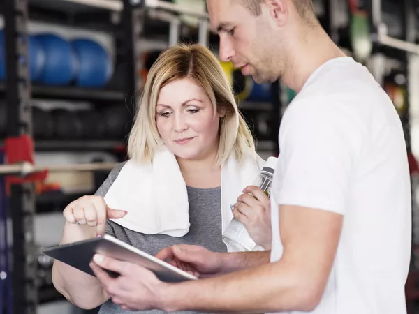 Woman talking to a fitness coach