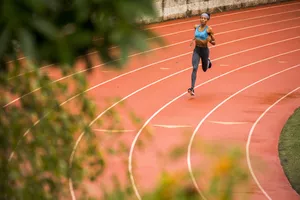 Black woman running on track