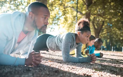 group doing the plank exercise outside