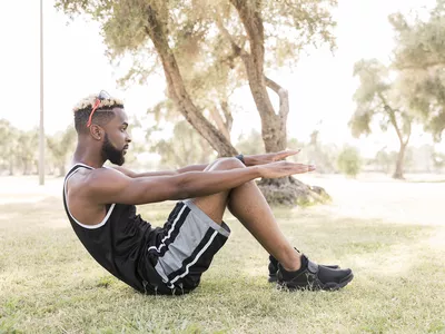 Man doing situps outdoors