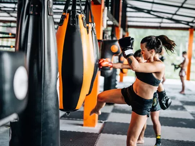 Woman kicking the punching bag