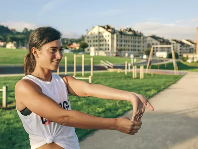 Woman doing tennis elbow wrist stretch