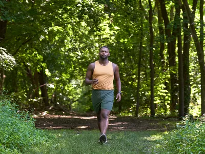 Man walking through trail