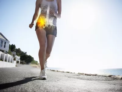 Photo of a woman running with hip pain.