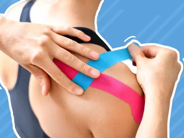 Kinesiology tape is applied to a person's shoulder in front of blue background