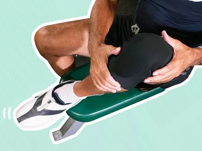 Person holding their knee clad in a knee brace outlined in white and displayed on a blue striped background 