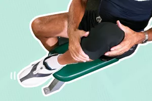 Person holding their knee clad in a knee brace outlined in white and displayed on a blue striped background 