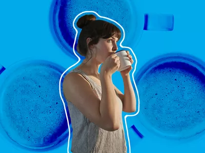 woman in tank top drinking a hot cup of coffee
