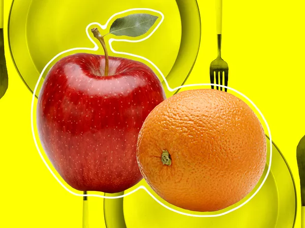 apples and orange over a place setting