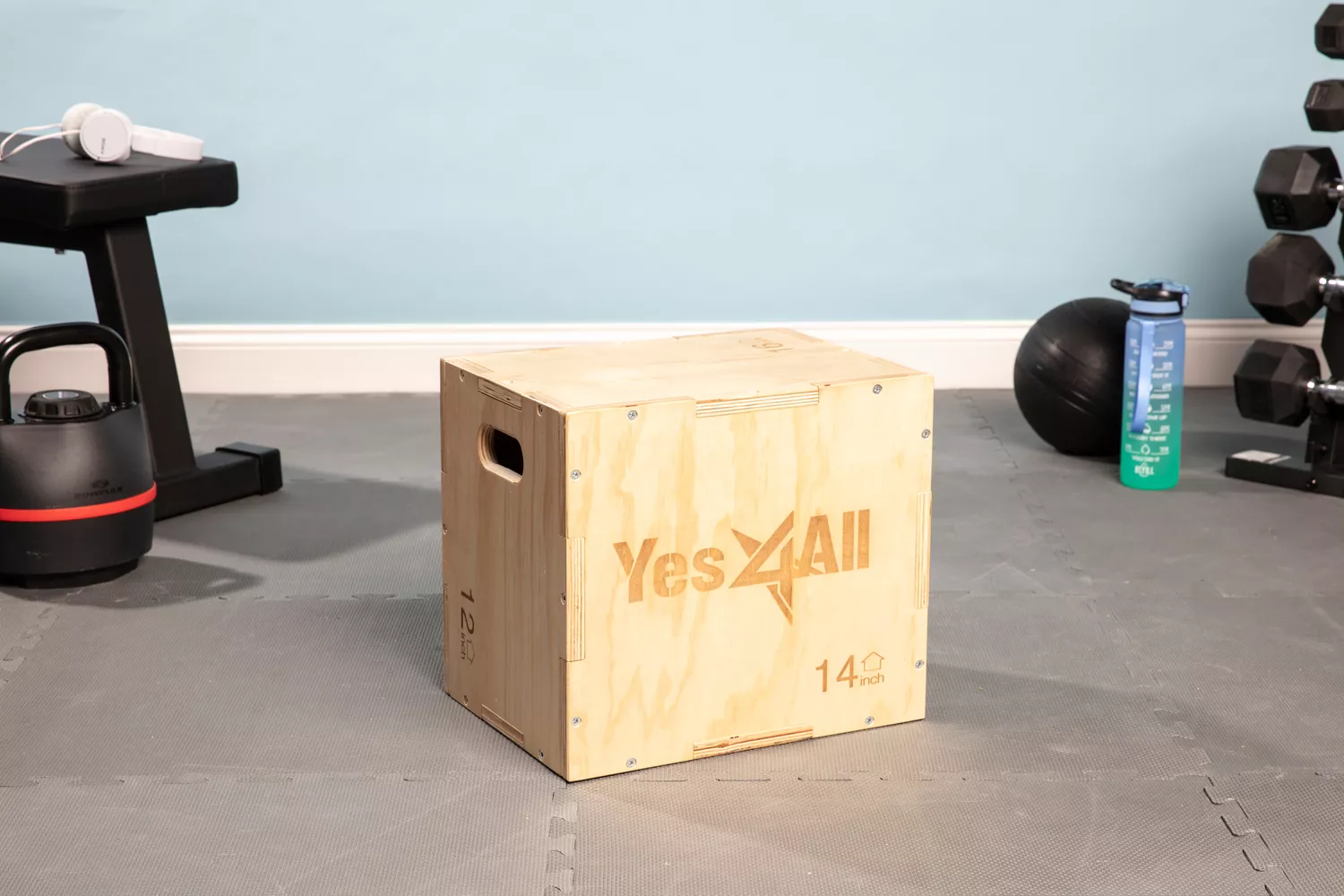 Yes4All 3-in-1 Wooden Plyo Box on gray floor surrounded by fitness equipment