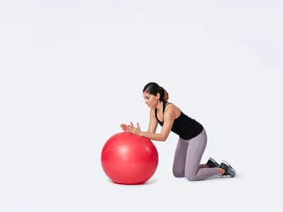 Woman preparing to do an ab rollout