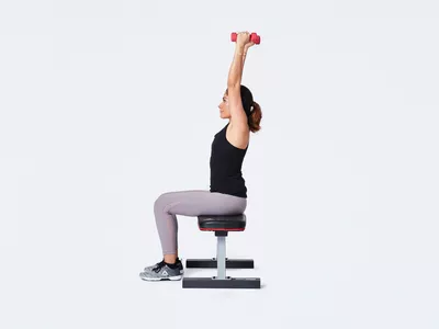 woman doing seated tricep extension