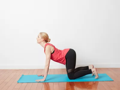 woman doing a cat cow stretch