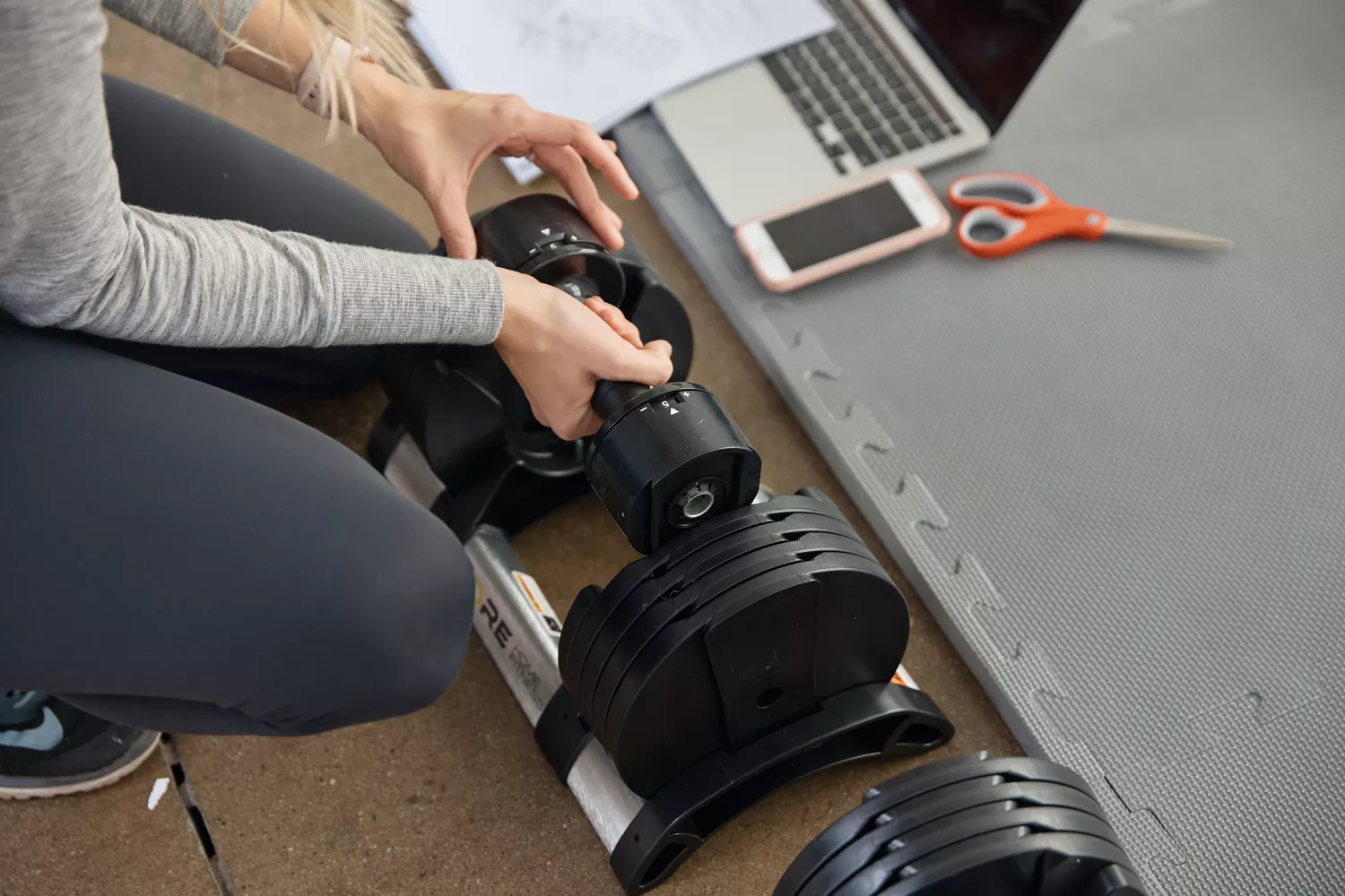 Hand adding weight To Core Home Fitness Twistlock Dumbells