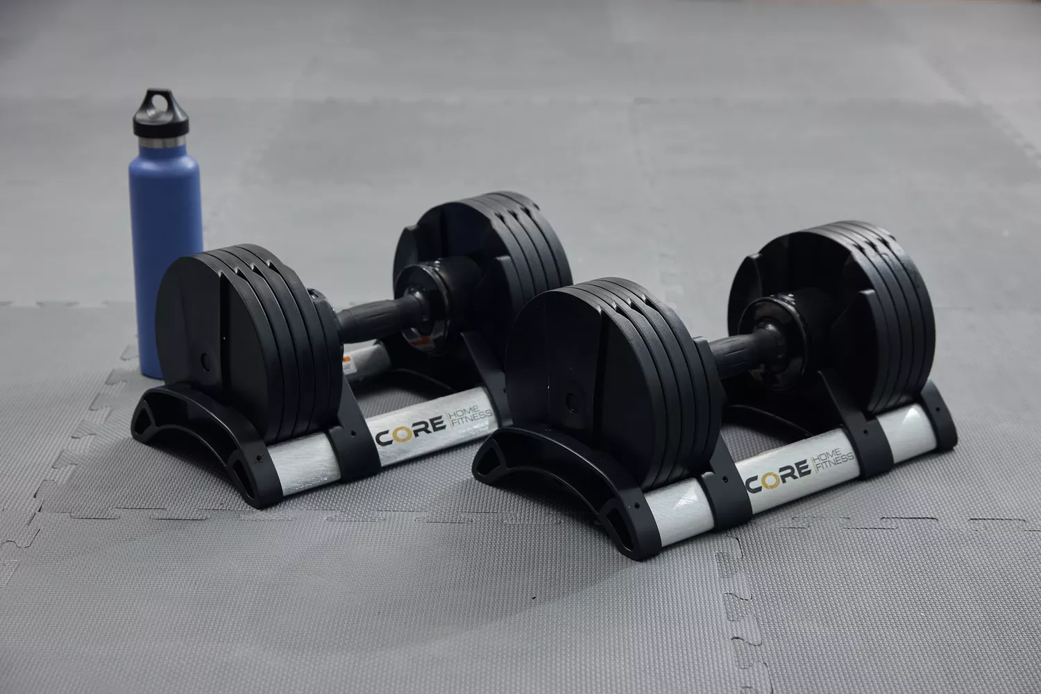 Core Home Fitness Twistlock Dumbells on stands set on gray mat