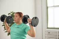 Women lifting Nuobell Adjustable Dumbbells