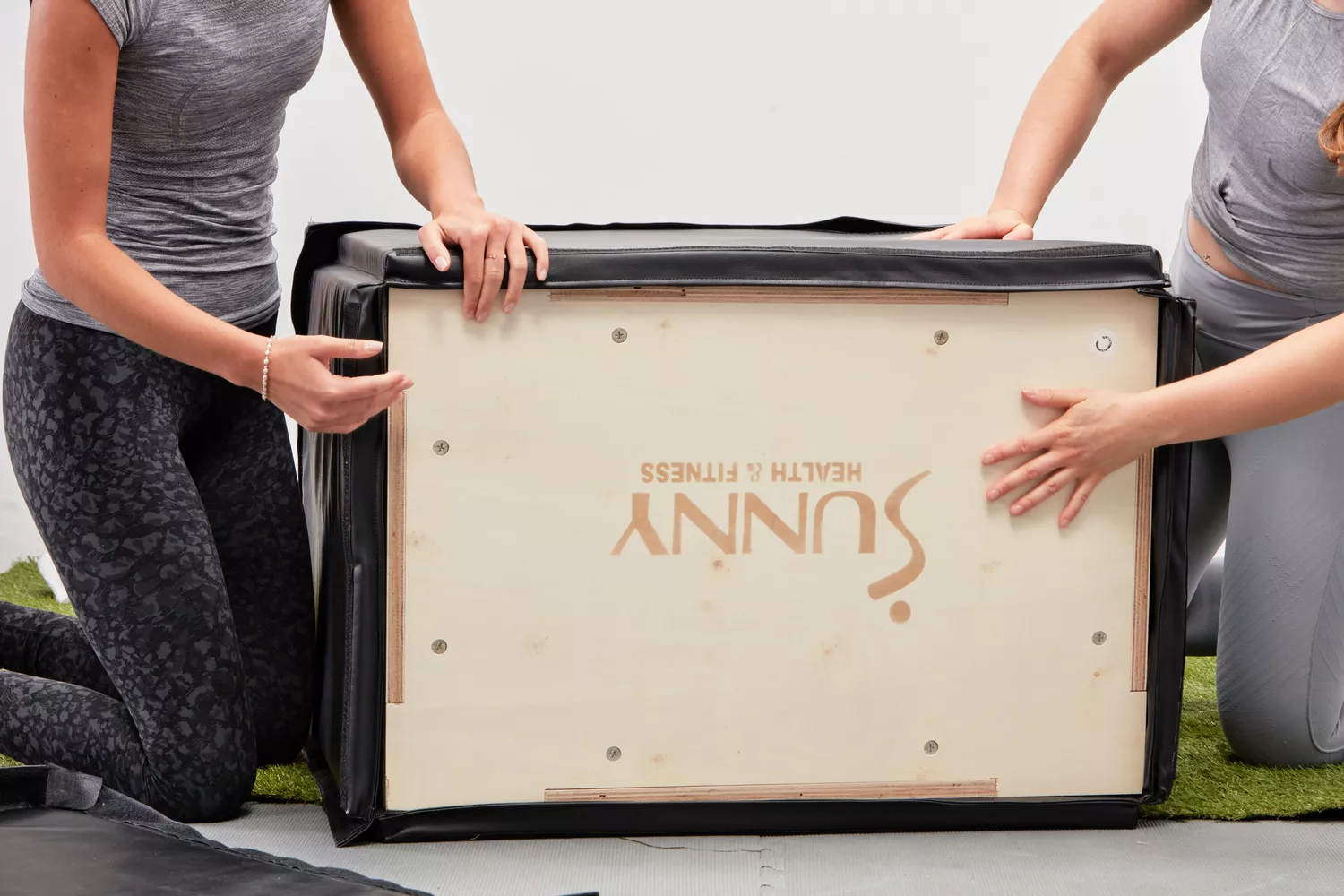 People assembling the Sunny Health & Fitness plyo box