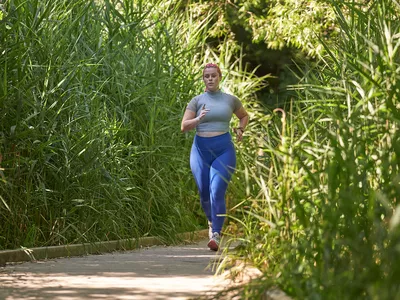 woman running on trail in park