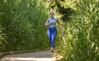 woman running on trail in park