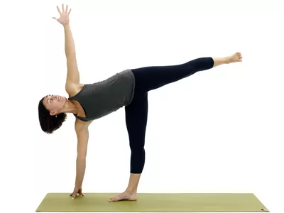 Woman doing half moon pose