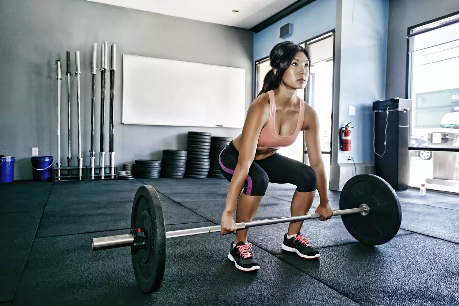 Woman doing deadlifts in a gym