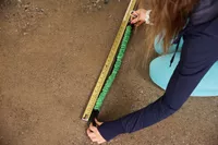 A person measuring the bands of the BodyBoss 2.0 Full Portable Home Gym before use.