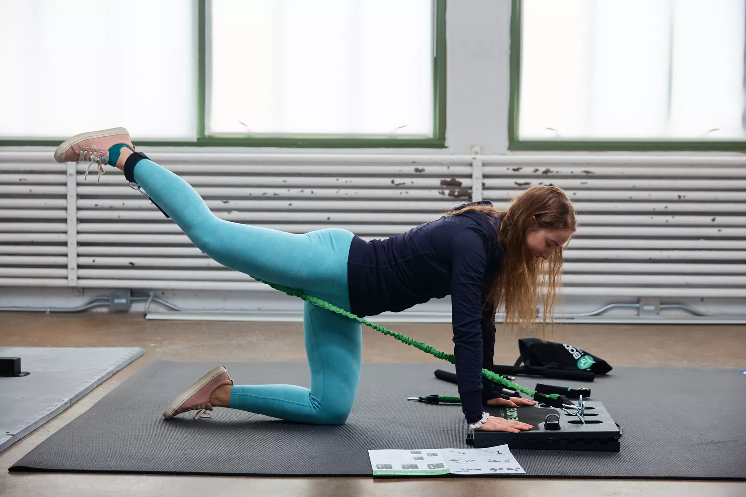 A person using a resistance band from the BodyBoss 2.0 Full Portable Home Gym to work their legs. 
