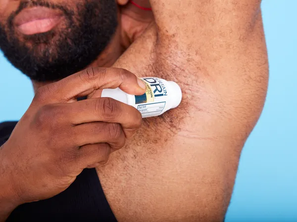 Person applying Certain Dri Clinical Prescription Strength Antiperspirant to their underarm
