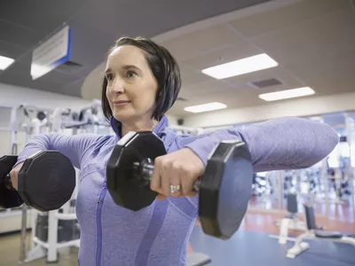 Woman weight lifting at gym