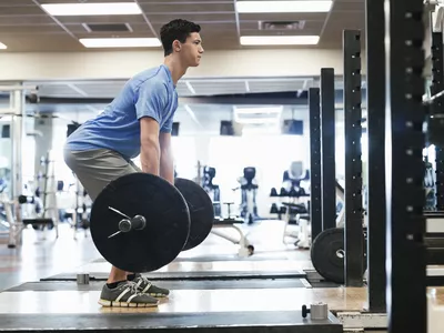 man doing deadlift in gym