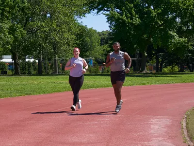man and woman running on a track