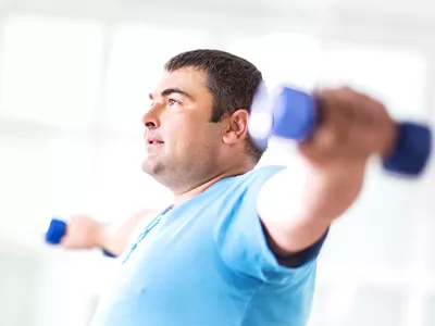 man exercising with dumbbells.