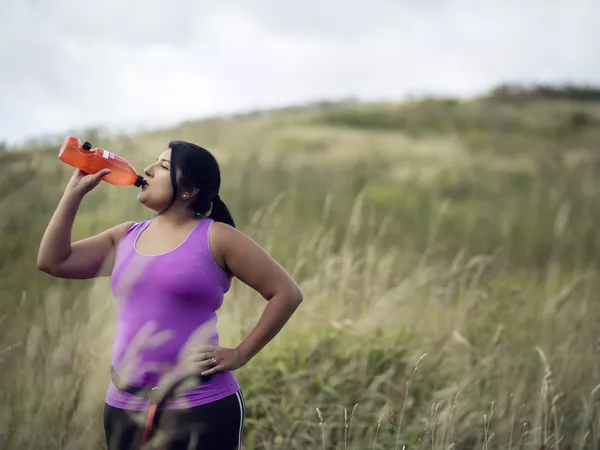 Female jogger drinking water