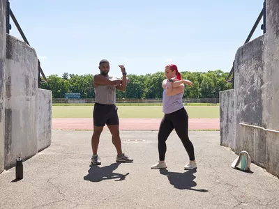 Man and woman stretching outside