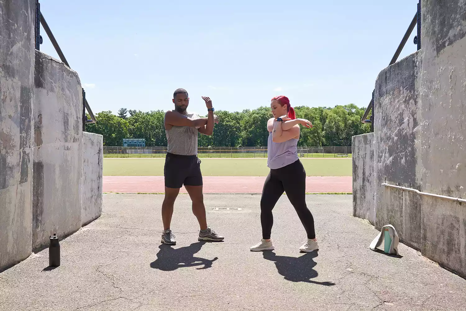 Man and woman stretching outside