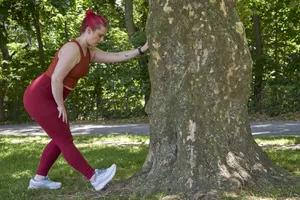 woman all in red stretching leg and food