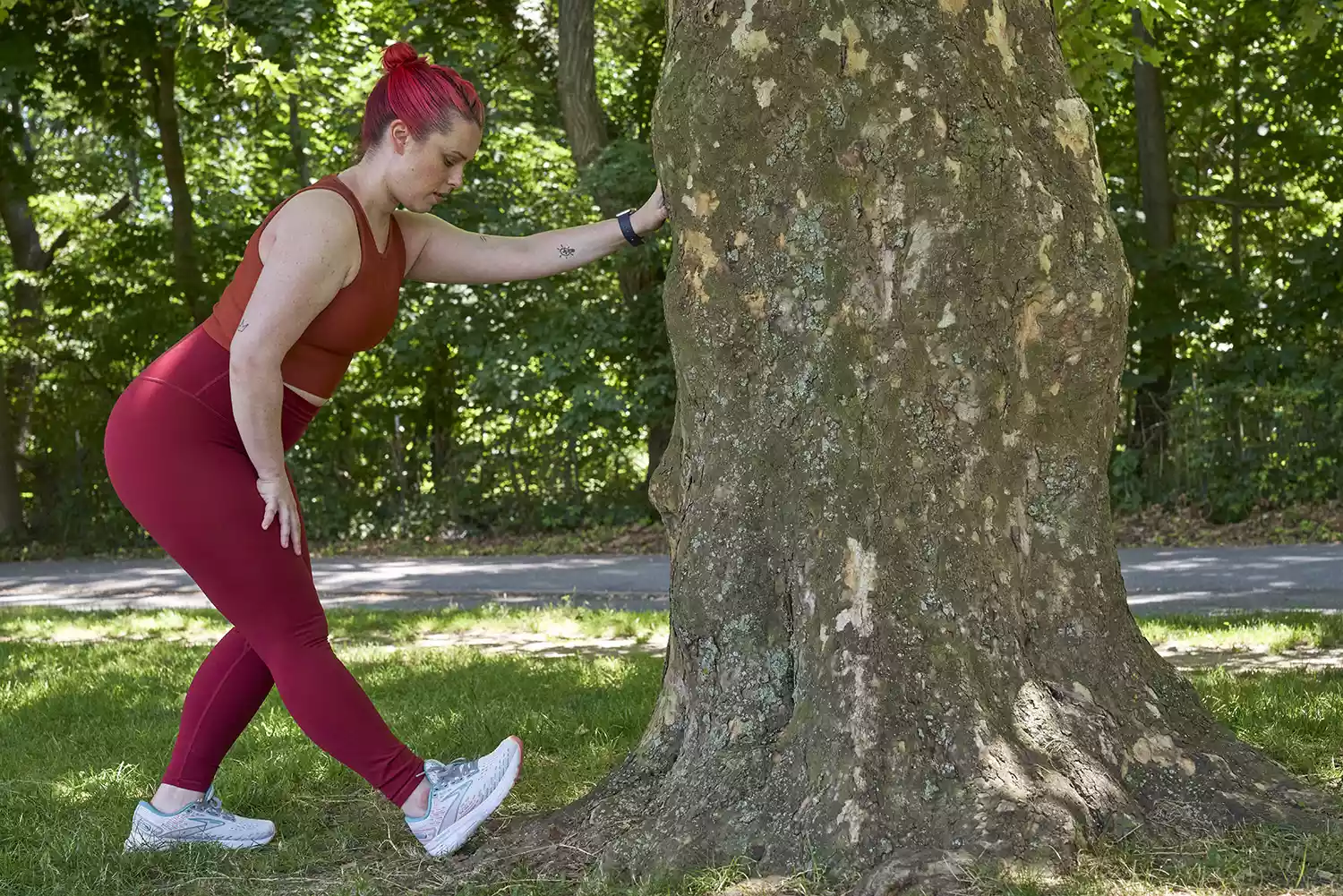 woman all in red stretching leg and food