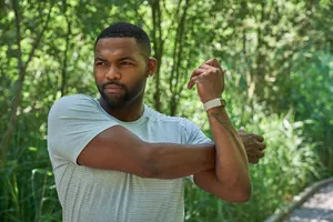 man stretching arms and shoulders