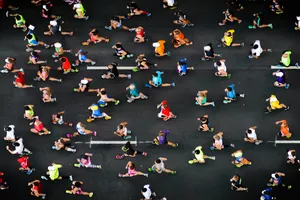 Marathon runners running on paved road