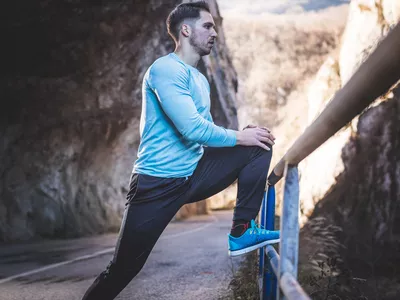 Man stretching on a run