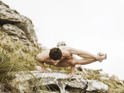 Man practicing yoga on a rock, South Africa