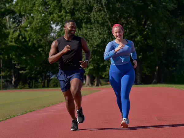 man and woman running laughing at running jokes