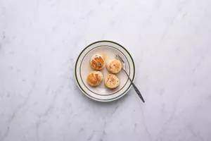 Scallops in a bowl with a fork