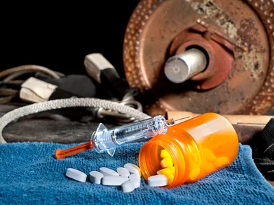 Barbell and pills and syringe