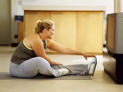 Woman stretching in front of her tv