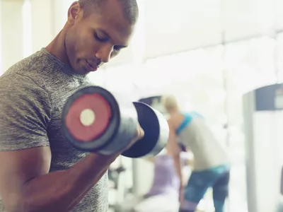 African American man toning his triceps in the gym