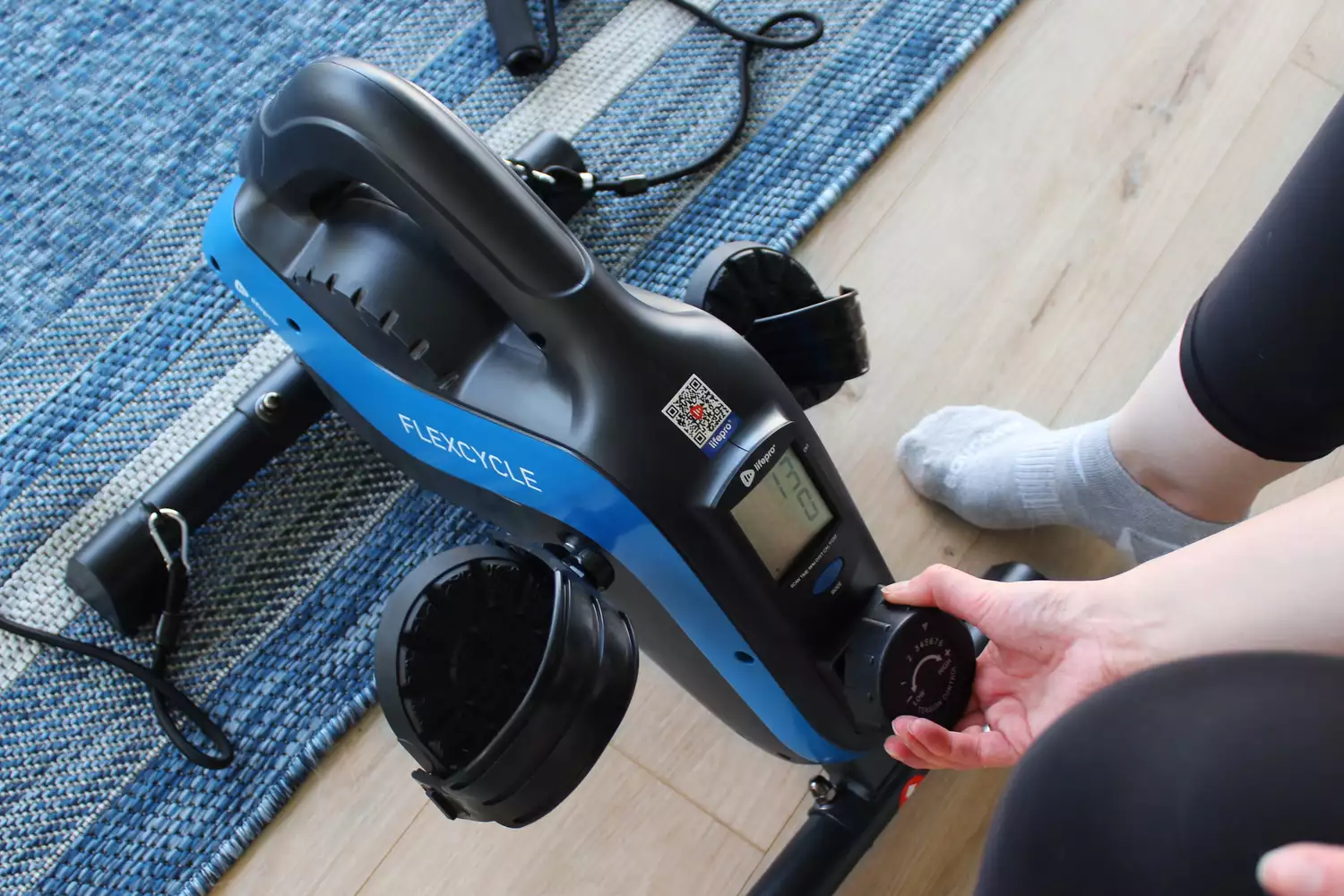 Person turning knob on LifePro FlexCycle Exercise Bike
