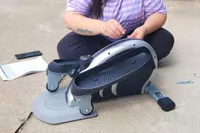 A Person putting the Stamina InMotion E1000 Compact Strider together