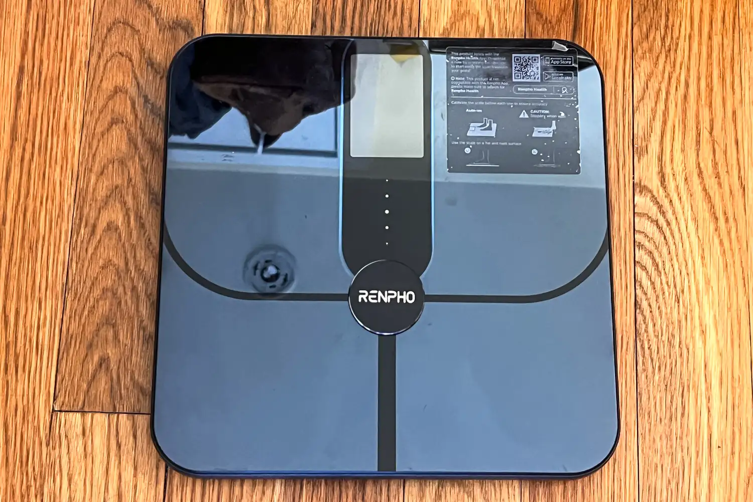 The Renpho Elis Nova Smart Scale on a wooden floor